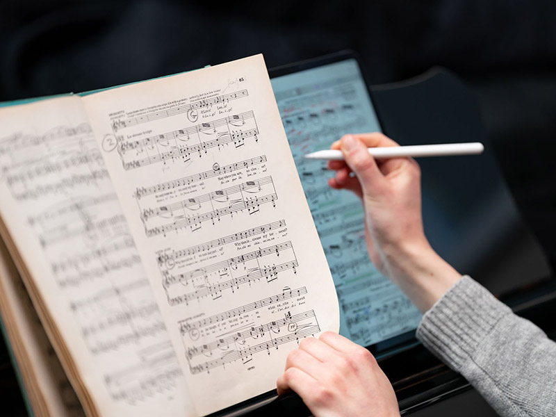 Close up of someone marking up sheet music