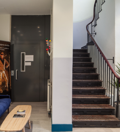 Sofa, coffee table and stair way in a room for hire