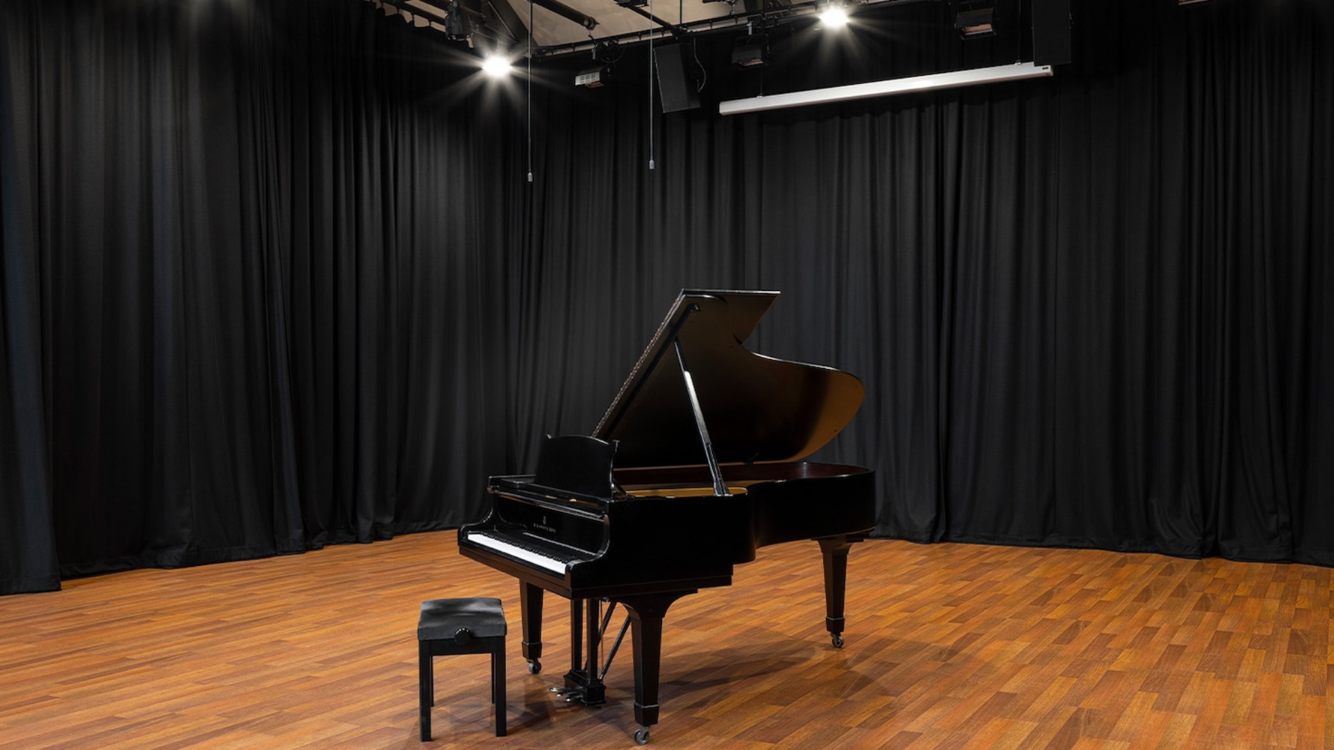 A grand piano in the national opera studio blackburn hall, available for hire