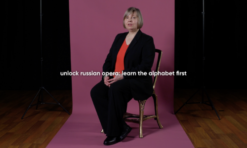 Lada Valešová in a black suit and red top in front of a paper background. Text reads: unlock Russian opera: learn the alphabet first